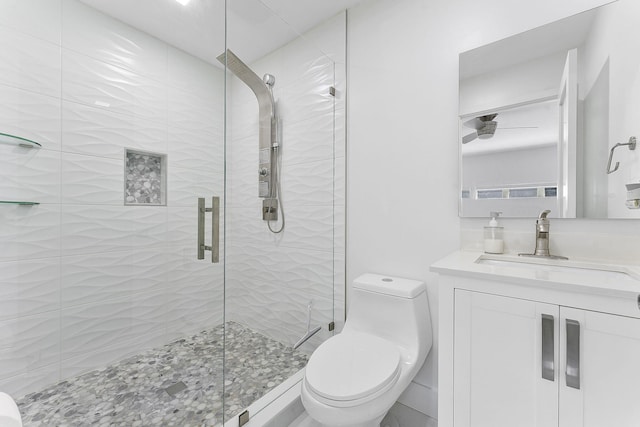 bathroom featuring vanity, toilet, and an enclosed shower