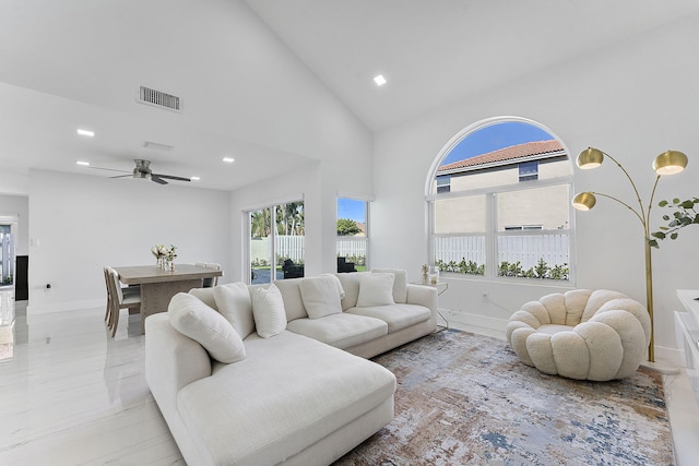 living room featuring ceiling fan and high vaulted ceiling