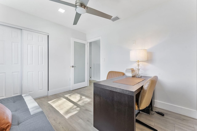 home office with ceiling fan, french doors, and light hardwood / wood-style flooring