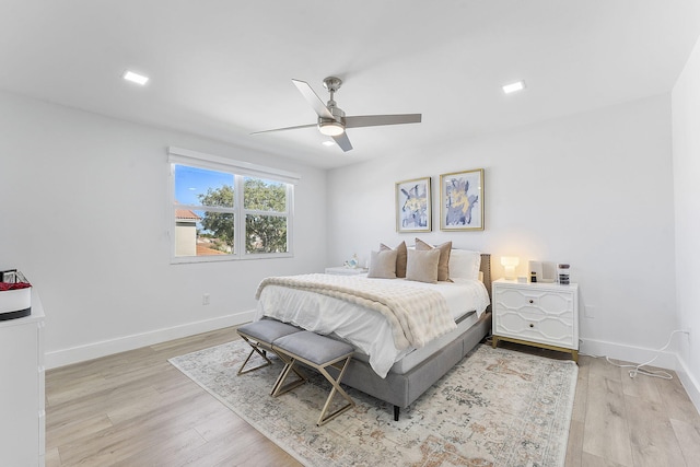 bedroom with light hardwood / wood-style flooring and ceiling fan