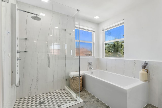 bathroom with separate shower and tub