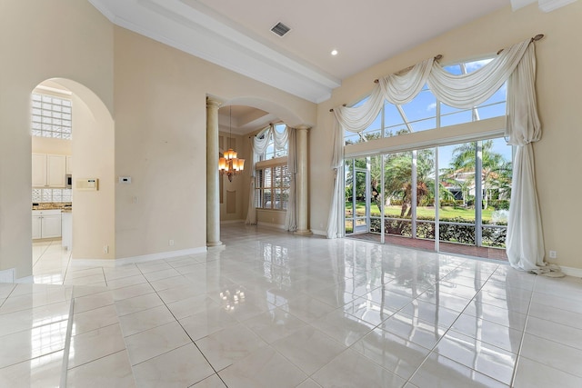 empty room with a high ceiling and a chandelier