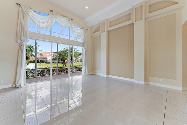 tiled empty room with a high ceiling