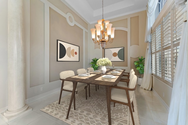 dining room with an inviting chandelier, a raised ceiling, crown molding, light tile patterned floors, and decorative columns