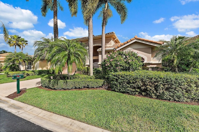 mediterranean / spanish house with a front lawn