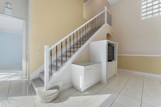 staircase featuring tile patterned floors