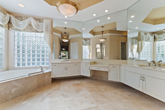 bathroom with vanity and tiled bath