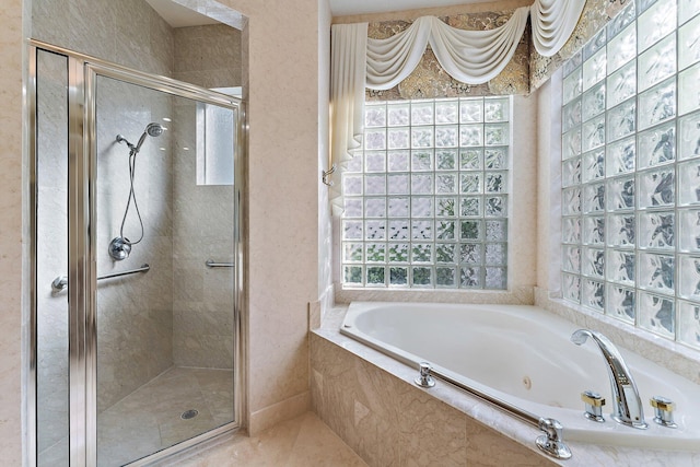 bathroom featuring separate shower and tub