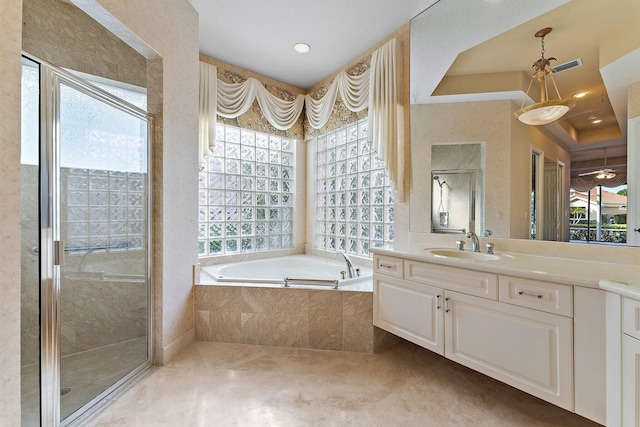 bathroom featuring vanity and shower with separate bathtub