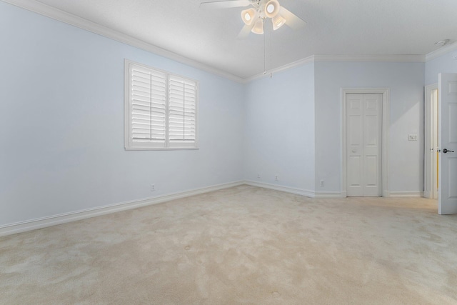 carpeted empty room with ceiling fan and crown molding