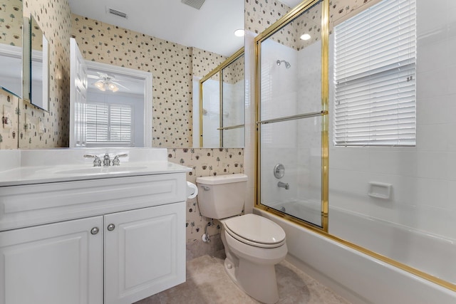 full bathroom with vanity, toilet, ceiling fan, and bath / shower combo with glass door