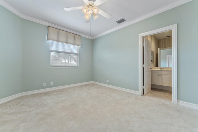 carpeted spare room featuring ceiling fan and crown molding