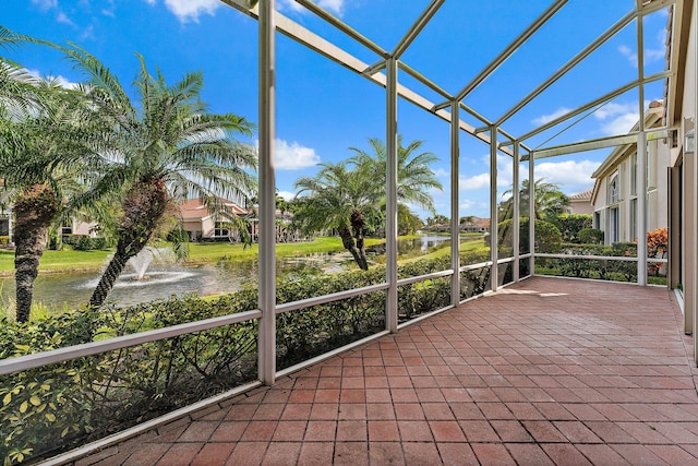 unfurnished sunroom with a water view