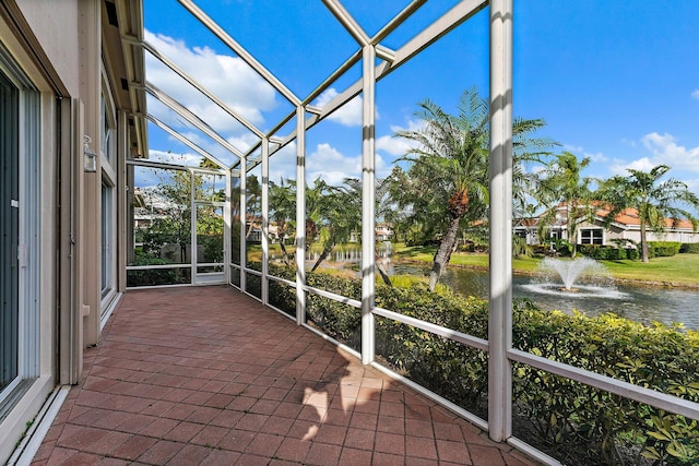 unfurnished sunroom featuring a water view