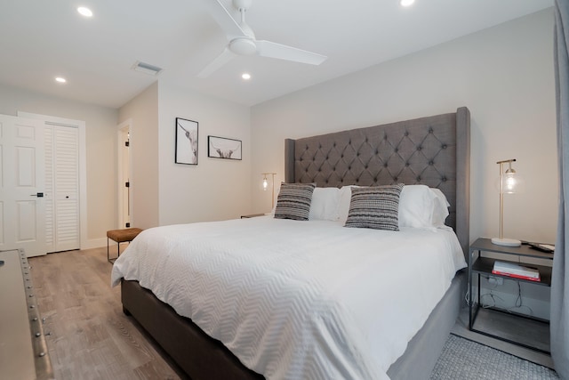 bedroom with ceiling fan, light wood-type flooring, and a closet