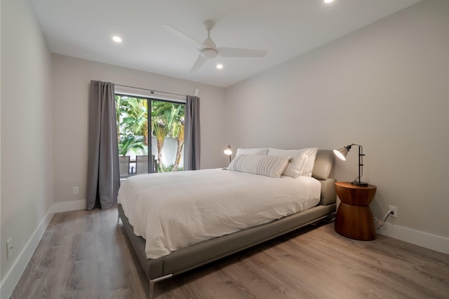 bedroom featuring hardwood / wood-style floors, ceiling fan, and access to exterior