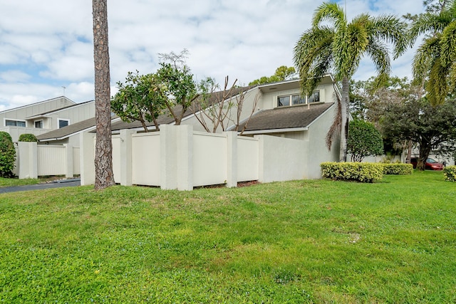 view of side of property with a yard