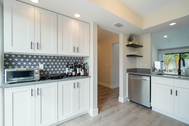 kitchen featuring dishwasher, white cabinets, light hardwood / wood-style floors, and sink