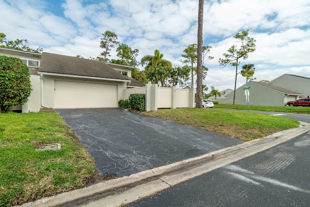 view of front facade with a front yard and a garage