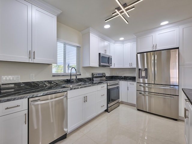 kitchen with appliances with stainless steel finishes, white cabinets, and sink