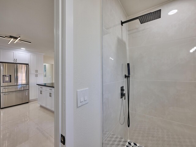 bathroom featuring a shower with shower door and vanity