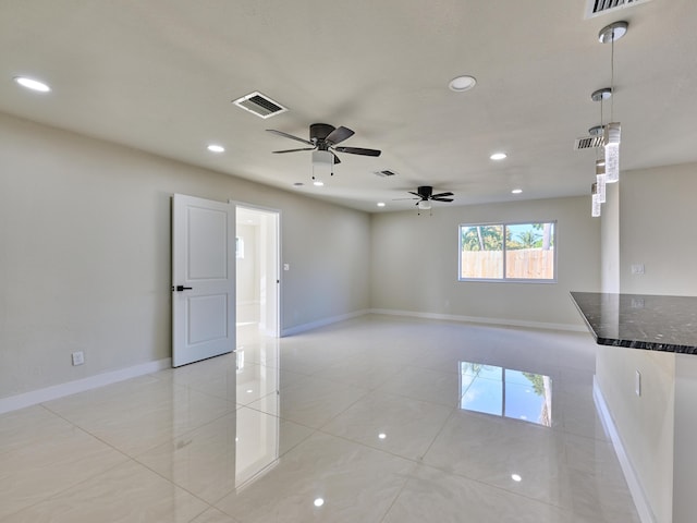 empty room featuring ceiling fan and light tile patterned flooring