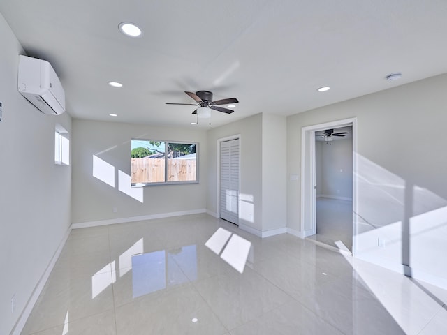 empty room featuring ceiling fan and a wall mounted AC