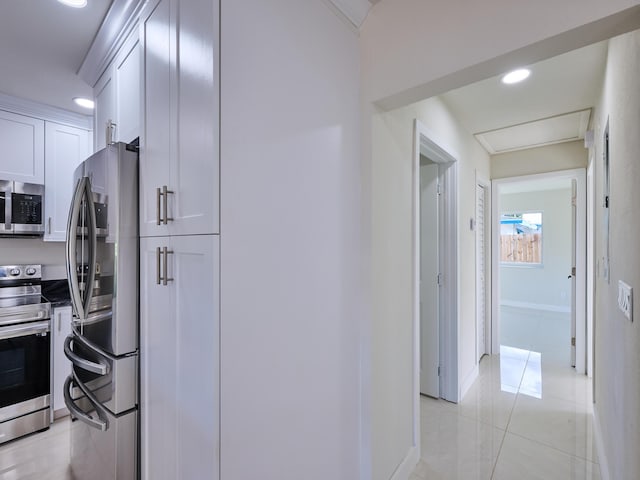 kitchen featuring stainless steel appliances and white cabinetry