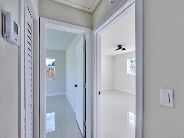 corridor with light tile patterned floors