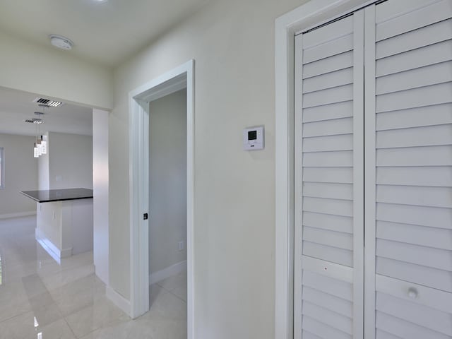 hallway featuring light tile patterned floors