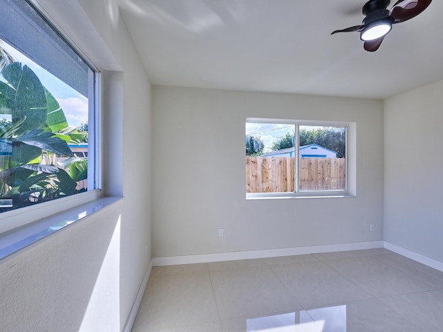 tiled empty room with ceiling fan