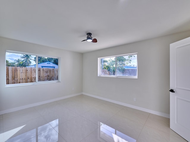 unfurnished room featuring ceiling fan and light tile patterned floors