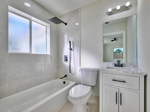 full bathroom featuring ceiling fan, toilet, tile patterned floors, vanity, and tiled shower / bath combo