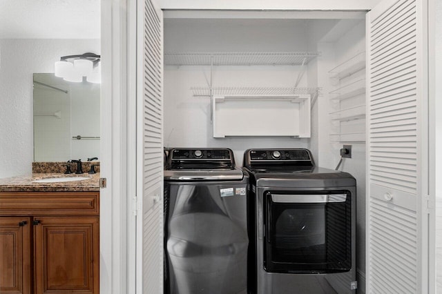 laundry area featuring washer and clothes dryer and sink