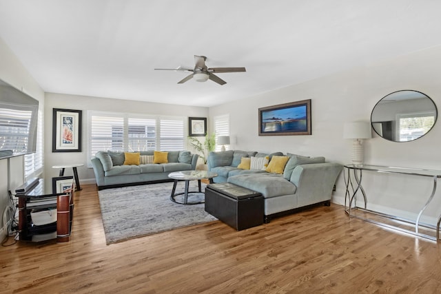 living room featuring hardwood / wood-style flooring and ceiling fan