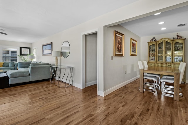 dining area featuring ceiling fan and dark hardwood / wood-style flooring