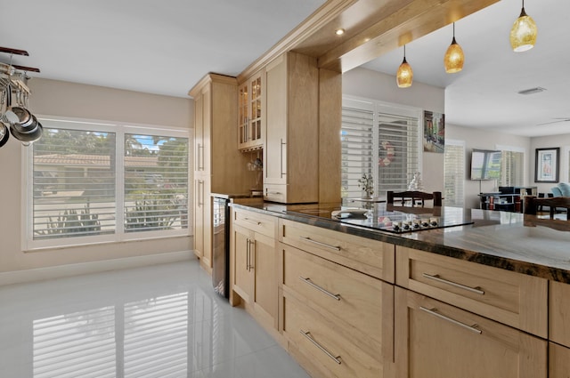 kitchen featuring decorative light fixtures, dark stone countertops, wine cooler, light tile patterned floors, and light brown cabinets