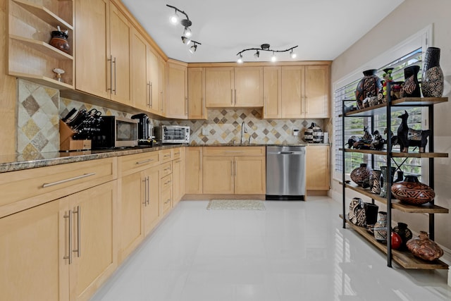 kitchen featuring light brown cabinetry, sink, decorative backsplash, stainless steel appliances, and light stone countertops