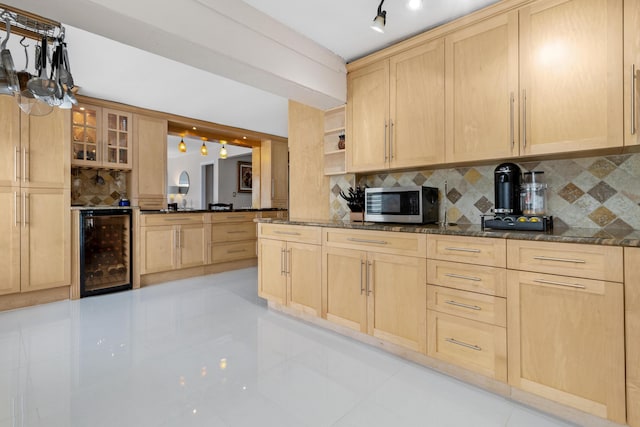 kitchen featuring decorative backsplash, beverage cooler, and light brown cabinets