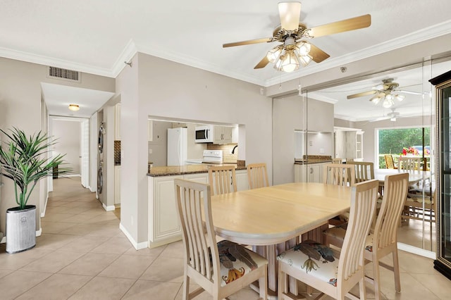 tiled dining room featuring crown molding and ceiling fan