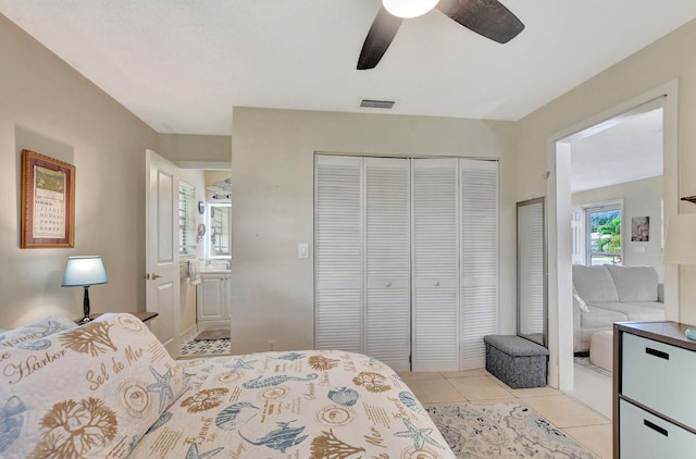 tiled bedroom featuring ceiling fan