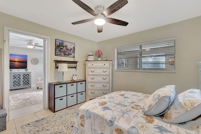 tiled bedroom featuring ceiling fan