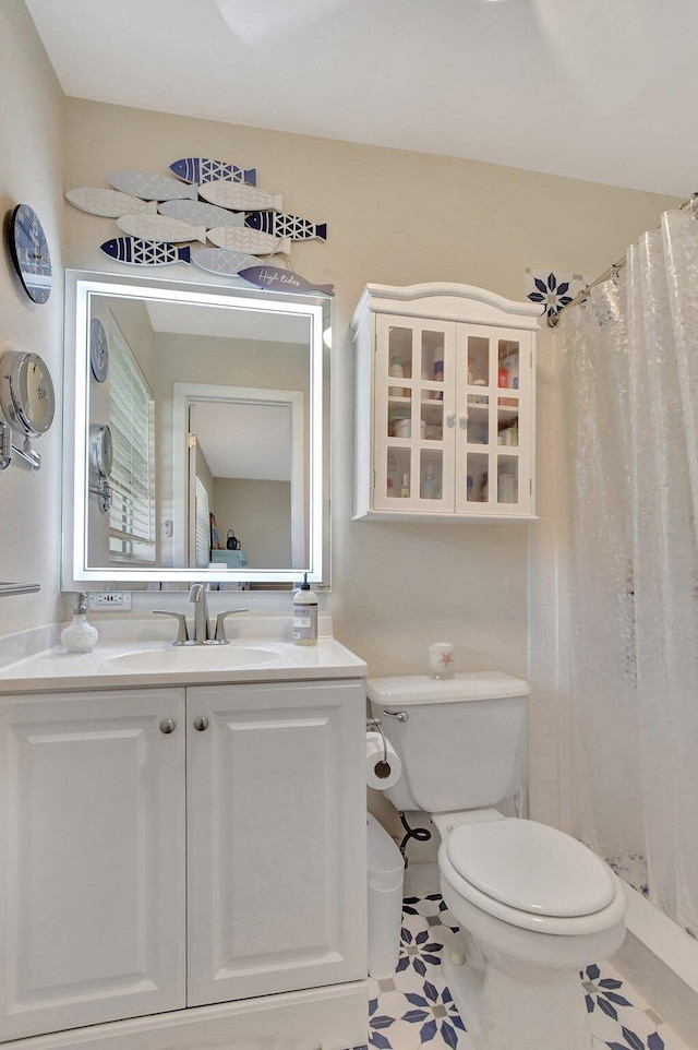 bathroom featuring a shower with curtain, tile patterned flooring, vanity, and toilet