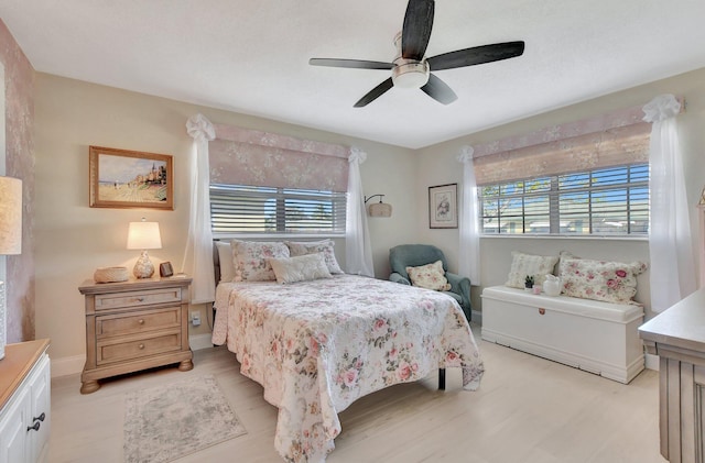 bedroom with multiple windows and ceiling fan