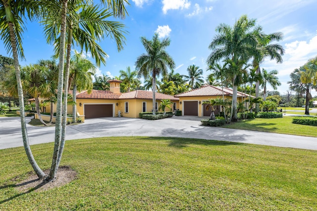 mediterranean / spanish home with a front yard