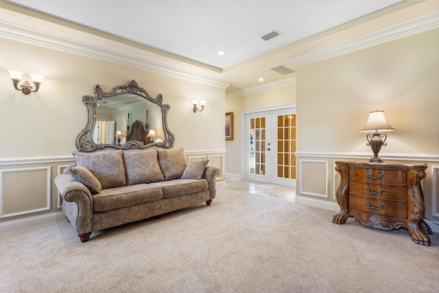 carpeted living room featuring french doors and ornamental molding