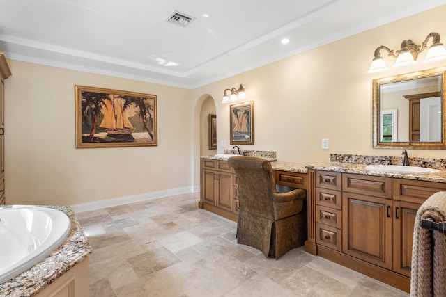 bathroom featuring vanity, crown molding, and a bathing tub