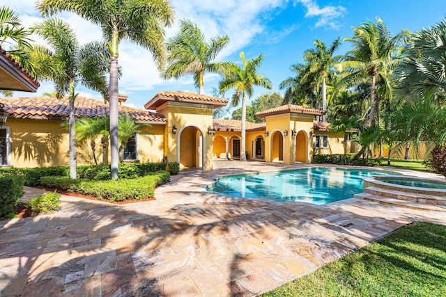 view of swimming pool with a patio and an in ground hot tub