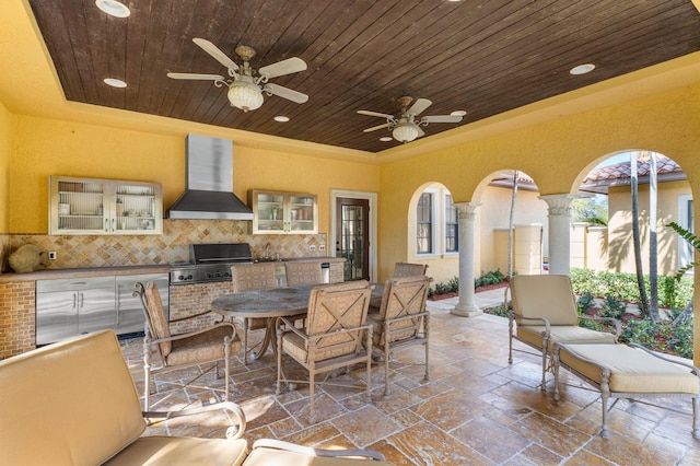 view of patio / terrace with grilling area, ceiling fan, and an outdoor kitchen