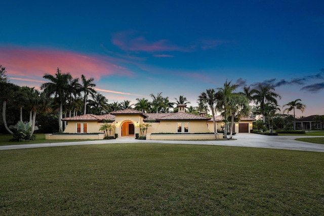 mediterranean / spanish-style house featuring a lawn